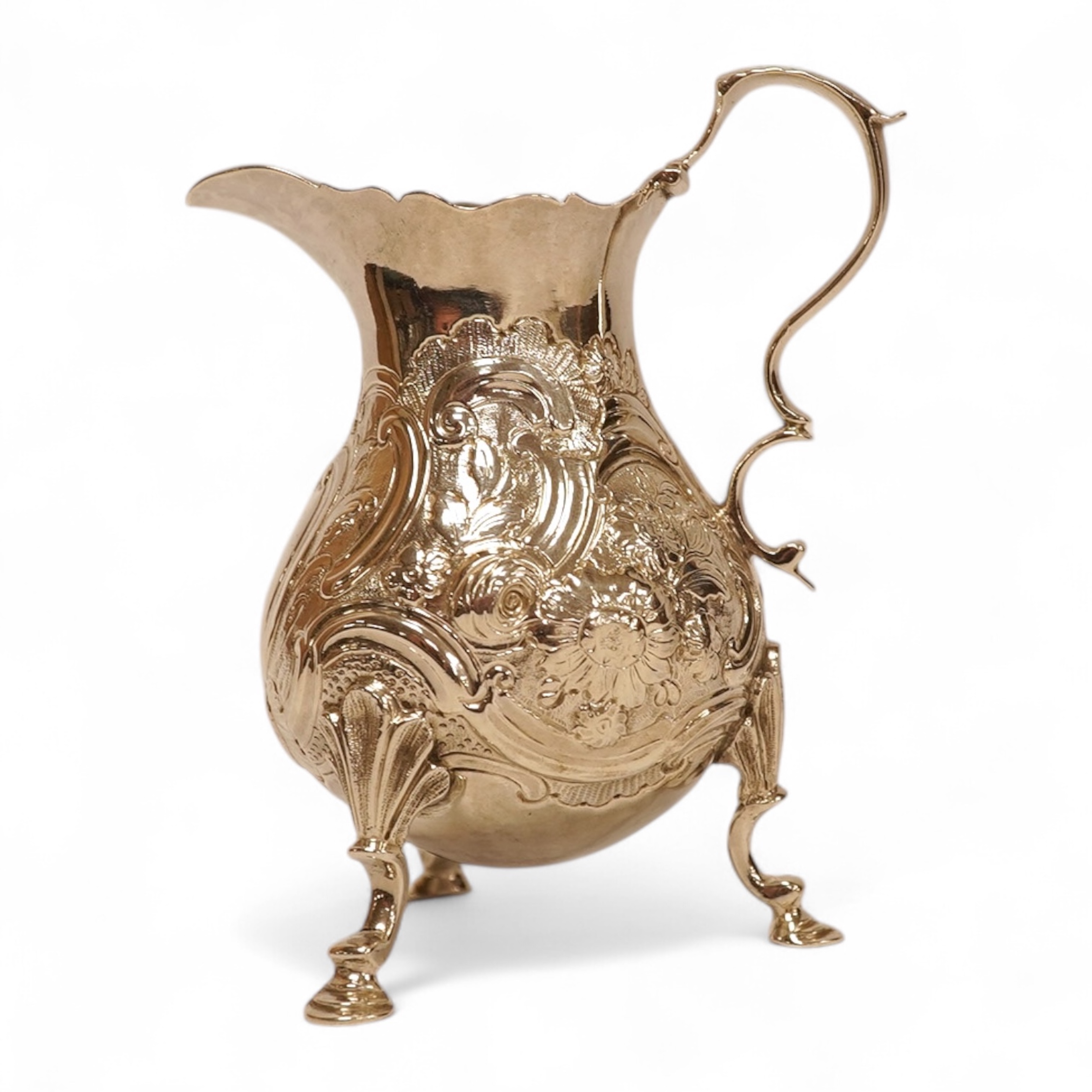 A late George II silver baluster cream jug, with later embossed decoration, on three hoof feet, Samuel Meriton I London, 1756, 10.6cm, 3.3oz.